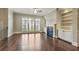 Bright living room with hardwood floors, fireplace, built-in bookshelves, and large windows at 1117 Cordia Ave, Atlanta, GA 30318