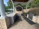 Covered outdoor kitchen with built-in grill, sink, and refrigerator at community pool at 1117 Cordia Ave, Atlanta, GA 30318