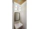 Stylish powder room featuring modern lighting, a decorative mirror, and sleek fixtures at 1117 Cordia Ave, Atlanta, GA 30318