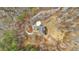 An overhead view captures the home's unique architectural design within a wooded landscape at 1452 Redwine Rd, Fayetteville, GA 30215