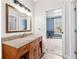 Bathroom vanity featuring a granite countertop and a view into an adjacent blue bedroom at 1452 Redwine Rd, Fayetteville, GA 30215