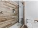 Bathroom featuring a tiled shower with glass, and a white toilet at 1452 Redwine Rd, Fayetteville, GA 30215