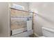 Clean bathroom featuring a tiled shower-tub combination with a sliding glass door at 1452 Redwine Rd, Fayetteville, GA 30215