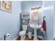 Cozy bathroom with pedestal sink, toilet, and a small shelf with decorative items at 1452 Redwine Rd, Fayetteville, GA 30215