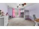 Light-filled bedroom featuring a loft bed, desk and dresser at 1452 Redwine Rd, Fayetteville, GA 30215