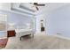 Bright and spacious bedroom featuring a tray ceiling, carpeted floors, and large windows at 1452 Redwine Rd, Fayetteville, GA 30215