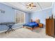 Bright bedroom with a blue painted walls and a window that brings in natural light at 1452 Redwine Rd, Fayetteville, GA 30215