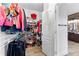Walk-in closet with built in shelving and hanging racks leading to an en suite bathroom at 1452 Redwine Rd, Fayetteville, GA 30215