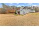 The home's rear exterior features a deck, walkout basement, and neutral siding blending with the natural landscape at 1452 Redwine Rd, Fayetteville, GA 30215
