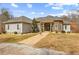 Lovely stone-accented home with brick walkway, manicured lawn, and charming architectural details at 1452 Redwine Rd, Fayetteville, GA 30215