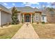Charming home featuring a stone facade, arched windows, and landscaped walkway at 1452 Redwine Rd, Fayetteville, GA 30215