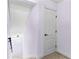 Hallway corner with view of the stairs to the basement and a door to an adjacent room at 1452 Redwine Rd, Fayetteville, GA 30215