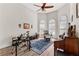 Bright living room features a piano, musical instruments, chair and arched windows at 1452 Redwine Rd, Fayetteville, GA 30215