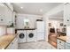 Bright and spacious laundry room featuring a washer and dryer next to a refrigerator at 170 Elysian Nw Way, Atlanta, GA 30327