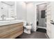 Modern bathroom with double vanity, toilet, and a laundry area with washer and dryer at 2230 Cheshire Bridge Ne Rd # 401, Atlanta, GA 30324