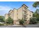 Attractive apartment building with multiple balconies surrounded by mature trees and lush greenery on a sunny day at 2230 Cheshire Bridge Ne Rd # 401, Atlanta, GA 30324