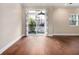 Bright living room featuring hardwood floors and sliding glass doors to a balcony at 2230 Cheshire Bridge Ne Rd # 401, Atlanta, GA 30324