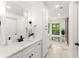 Bright bathroom with a marble tile floor, large mirrors, and a view of the trees outside at 2855 Lamer Trce, Marietta, GA 30066