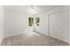 Bright bedroom with neutral carpet, a ceiling fan, two windows, and a double-door closet at 2855 Lamer Trce, Marietta, GA 30066