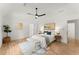 Bright bedroom with hardwood floors, ceiling fan, bench at the end of the bed, and minimalist decor at 2855 Lamer Trce, Marietta, GA 30066