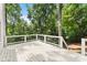 A white deck with black metal railings is surrounded by lush greenery at 2855 Lamer Trce, Marietta, GA 30066