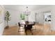 Bright dining room with modern light fixture, hardwood floors, and four chairs at 2855 Lamer Trce, Marietta, GA 30066