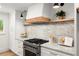 Gourmet kitchen featuring a marble countertop, stainless steel stove, and white cabinets at 2855 Lamer Trce, Marietta, GA 30066