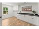 Well-lit laundry room features wooden floors, stylish decor, and storage cabinets at 2855 Lamer Trce, Marietta, GA 30066
