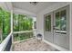 Cozy covered porch with stone flooring, black railing, and double doors leading inside at 2855 Lamer Trce, Marietta, GA 30066