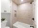 Tiled shower featuring a built-in shelf, tub, and modern fixtures in a bright bathroom with neutral colors at 2855 Lamer Trce, Marietta, GA 30066