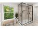 Glass enclosed shower features marble tile, a bench near the window, and modern fixtures at 2855 Lamer Trce, Marietta, GA 30066