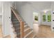 Modern staircase with wood steps and black railing leading to the upper level at 2855 Lamer Trce, Marietta, GA 30066