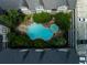 Aerial view showcasing the neighborhood pool, surrounded by lush trees and manicured landscaping at 1850 Cotillion Drive # 2118, Dunwoody, GA 30338