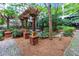 Lush landscaped common area with brick columns and wooden pergolas for seating at 1850 Cotillion Drive # 2118, Dunwoody, GA 30338