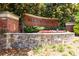 Attractive brick sign for Madison Square at Auburn Woods community entrance framed by colorful landscaping at 1850 Cotillion Drive # 2118, Dunwoody, GA 30338