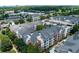 View of luxury condominium building with brick and beige siding, featuring balconies, roof detail and mature trees at 1850 Cotillion Drive # 2118, Dunwoody, GA 30338