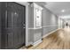 Neutral hallway with wood floors, leading to unit 2118 with a dark door and white trim at 1850 Cotillion Drive # 2118, Dunwoody, GA 30338
