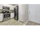 Well-equipped kitchen with white cabinets and stainless steel appliances near the entry door at 1850 Cotillion Drive # 2118, Dunwoody, GA 30338