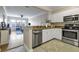 Open concept kitchen with white cabinets, stainless steel appliances, and view into living room at 1850 Cotillion Drive # 2118, Dunwoody, GA 30338
