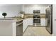 White kitchen with stainless steel appliances, including a refrigerator and oven at 1850 Cotillion Drive # 2118, Dunwoody, GA 30338