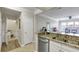 Open kitchen with stainless appliances, granite countertops, and views to the living area at 1850 Cotillion Drive # 2118, Dunwoody, GA 30338
