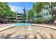 Beautiful community pool with water features, lounge chairs, and lush greenery at 1850 Cotillion Drive # 2118, Dunwoody, GA 30338