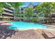 Inviting community pool with a tanning ledge and surrounding lounge chairs, perfect for relaxing at 1850 Cotillion Drive # 2118, Dunwoody, GA 30338