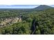 Breathtaking aerial view of a neighborhood nestled amidst lush forests with winding walking trail at 2050 Poplar Ridge Pl, Cumming, GA 30040