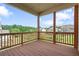 Cozy back porch features a wood floor and a railing, providing a relaxing outdoor living area at 2050 Poplar Ridge Pl, Cumming, GA 30040