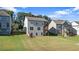The back of the home shows a beautiful lawn and deck that are ideal for outdoor entertaining at 2050 Poplar Ridge Pl, Cumming, GA 30040