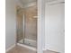 Modern bathroom featuring glass shower with tiled walls and updated fixtures adjacent to the white door at 2050 Poplar Ridge Pl, Cumming, GA 30040