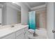 Bathroom includes white cabinets, a sink, a toilet, and a shower with a blue shower curtain at 2050 Poplar Ridge Pl, Cumming, GA 30040