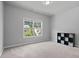 Well-lit bedroom showcasing a large window and ample storage with a clean, neutral aesthetic at 2050 Poplar Ridge Pl, Cumming, GA 30040