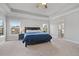 Large main bedroom with a trey ceiling, windows, carpeting, and a large ensuite bathroom at 2050 Poplar Ridge Pl, Cumming, GA 30040